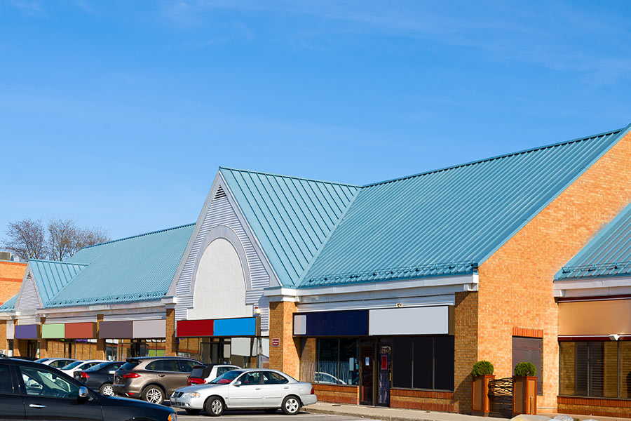 view of commercial building with blue roofing